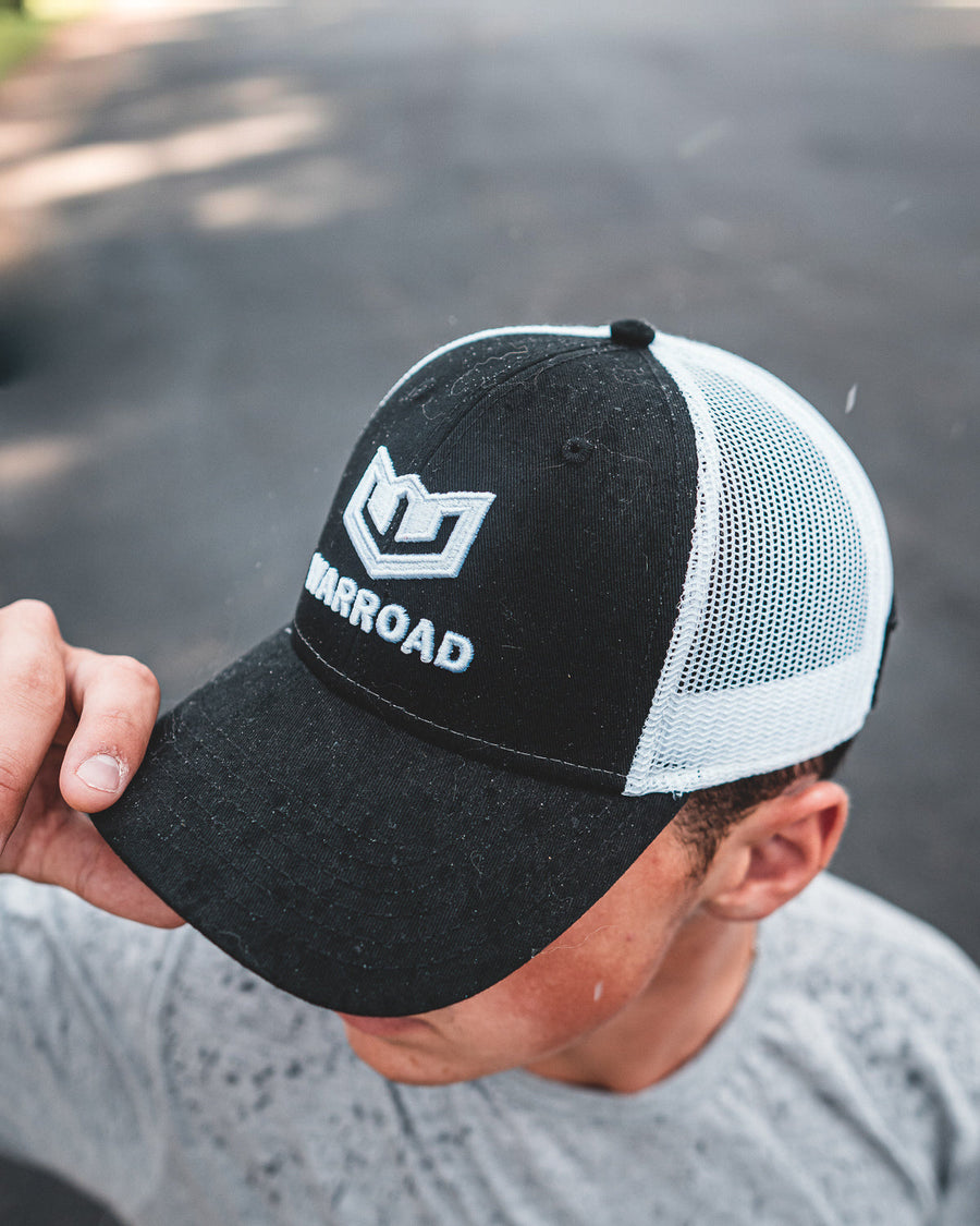 Warroad Championship Trucker Hat worn outdoors, hand on the brim - image 2