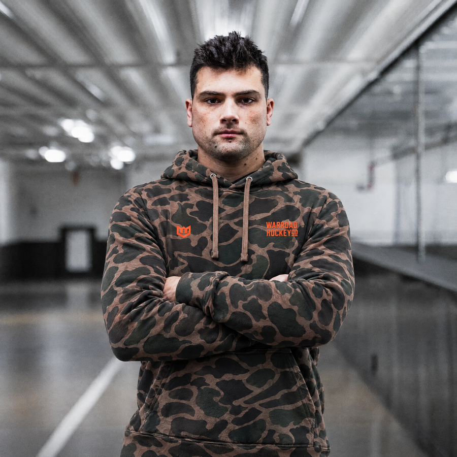 Original 6 Pullover Hoodie Midweight in Duck Camo worn, arms crossed - image 4