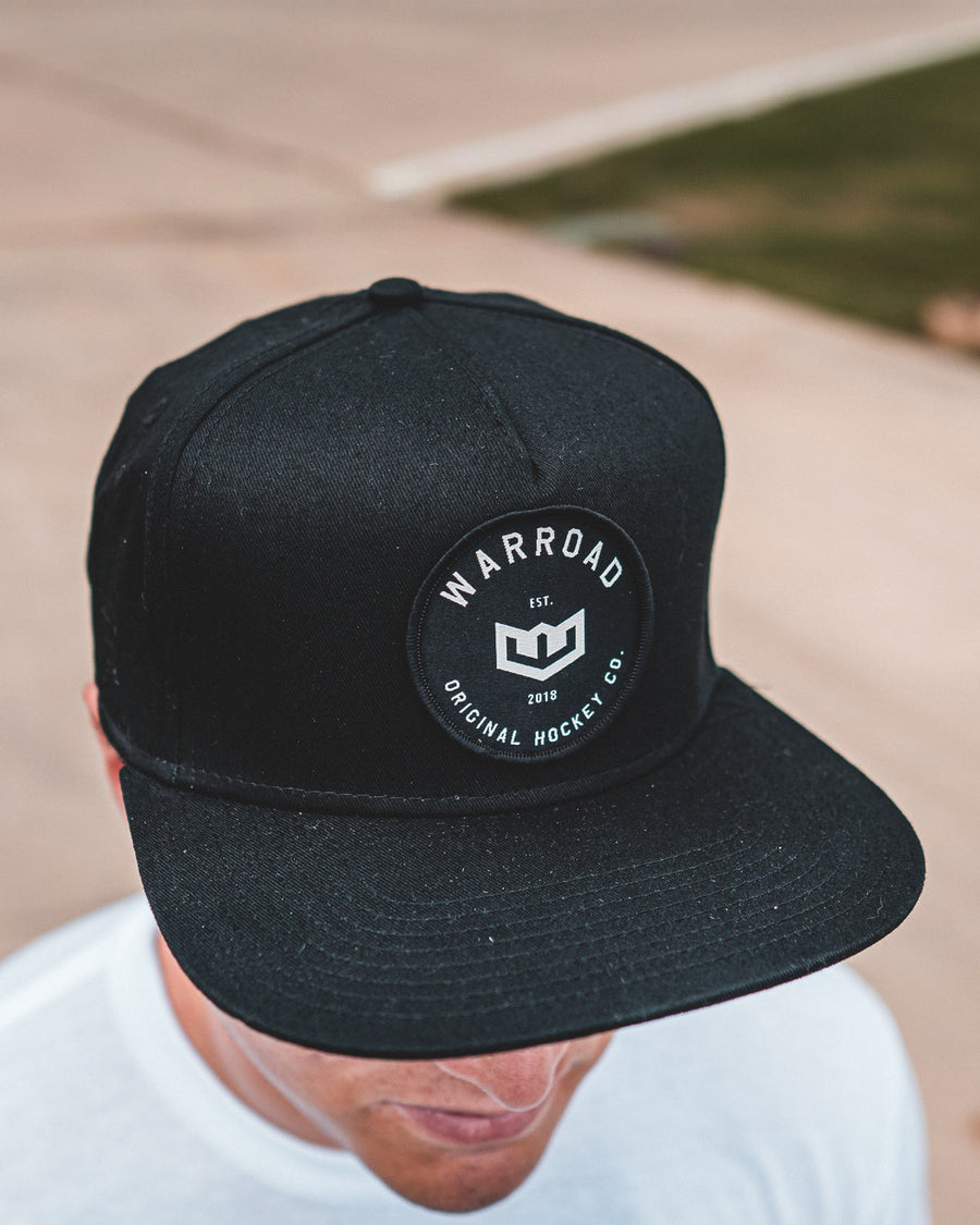 Warroad OG Hockey Hat in black worn outdoors, top view of the patch - image 2